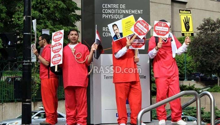 بالصور.. وقفة بالملابس الحمراء في كندا تنديدا بإعدام مرسي